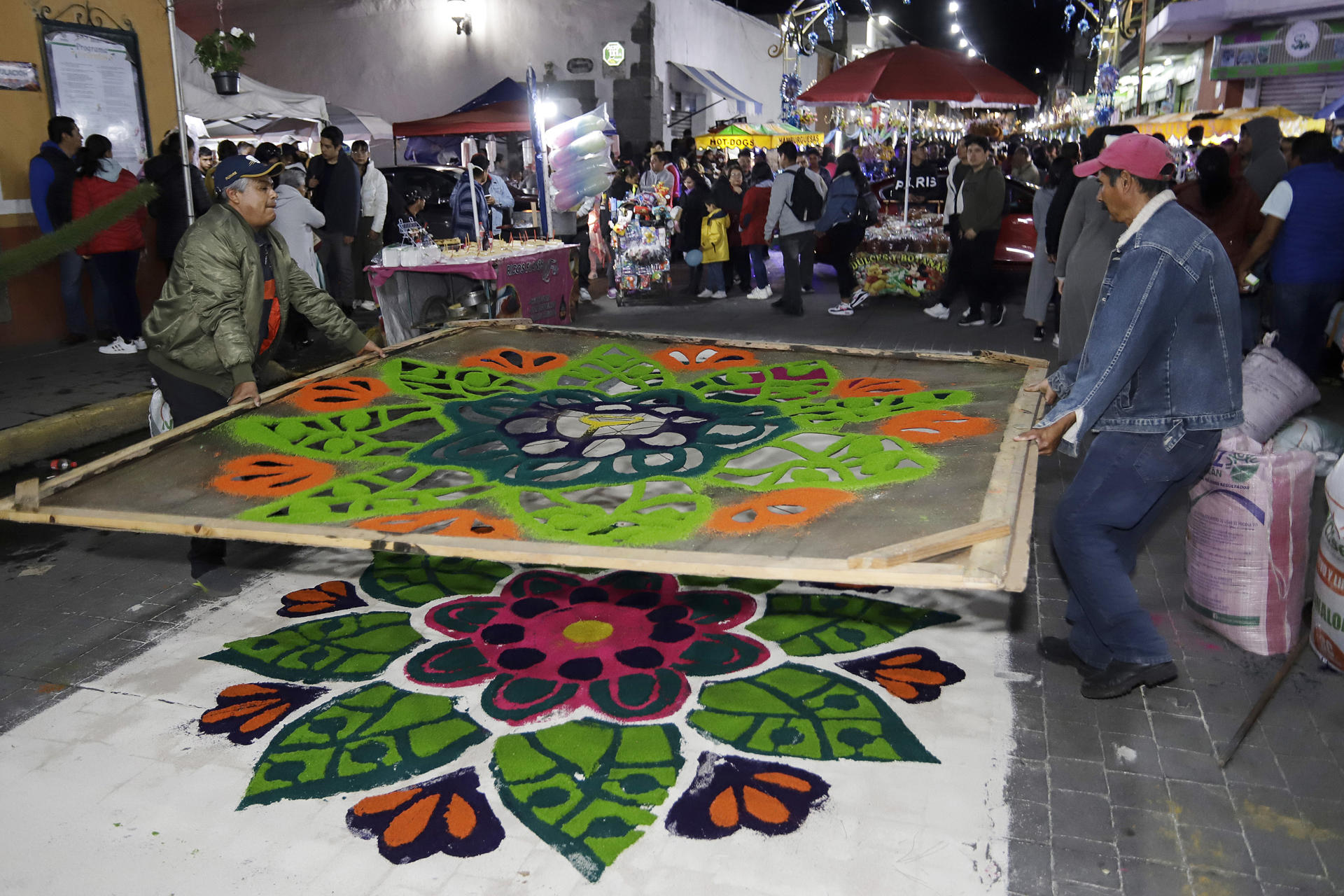 Fotografía del 14 de agosto de 2024 de artesanos elaborando tapetes de aserrín con distintos mosaicos y diseños para celebrar la ´Noche que Nadie Duerme', en el municipio de Huamantla, estado de Tlaxcala (México). EFE/Hilda Ríos
